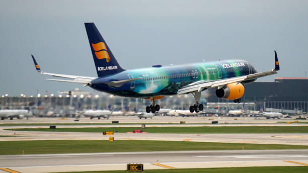 Icelandair Boeing 757 Prepares for Landing at Chicago O'Hare Chicago, IL, USA. Icelandair Boeing 757-200 with Aurora Borealis livery prepares for landing at Chicago O'Hare International Airport on a busy summer evening. boeing 757 stock pictures, royalty-free photos & images