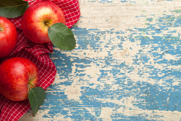 Gala red apple. Fresh fruits and green leaves on wooden table. Copy space. Top view