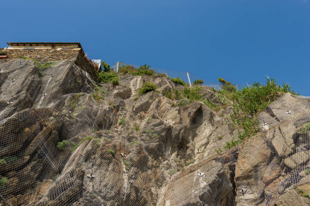 Close-up of a rockfall barrier with wire mesh on the cliff near the small village of Riomaggiore, Cinque Terre National Park in Liguria, La Spezia, Italy, Europe. UNESCO world heritage site.