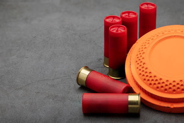 istock Clay shooting target and shotgun bullets on texture background ,Clay Pigeon target game 1330040305
