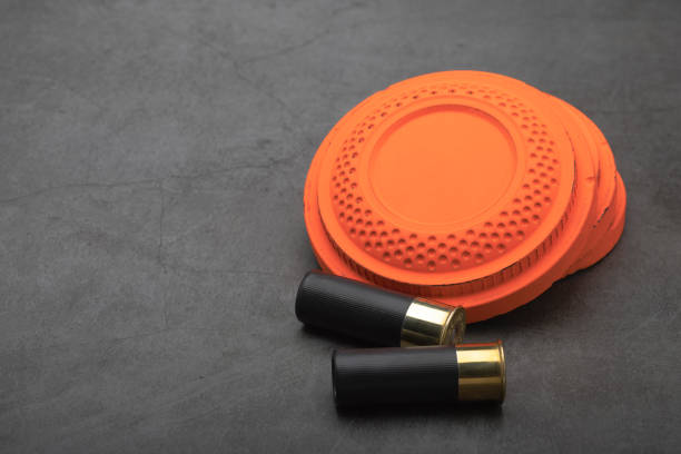 istock Clay shooting target and shotgun bullets on texture background ,Clay Pigeon target game 1330040322