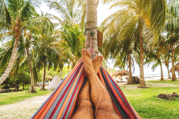 istock Young man relaxing in the hammock 1330040393