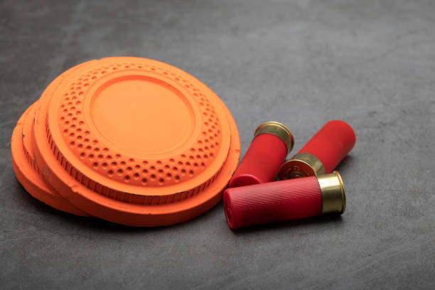 istock Clay shooting target and shotgun bullets on texture background ,Clay Pigeon target game 1330040482