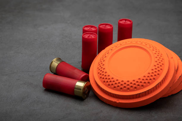 istock Clay shooting target and shotgun bullets on texture background ,Clay Pigeon target game 1330040531