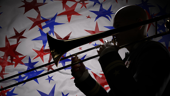 Trombone Player silhouetted in front of a banner of red and blue stars on a white background.