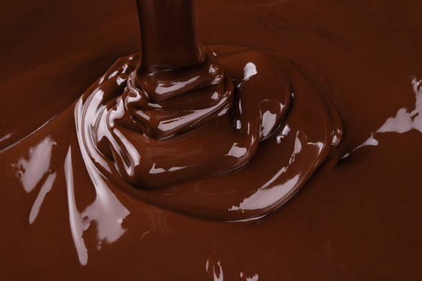 istock liquid dark chocolate flowing, sweet dessert background 1330042524