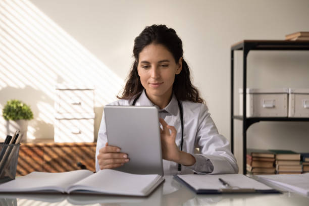 istock Caucasian female doctor talk on video call on tablet 1330045941