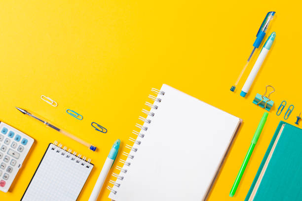 istock Book, copybook, notepad, clips and pencils on yellow background. Flat lay. Back to school banner with copy space. Mock up. Education and bussines concept 1330049283