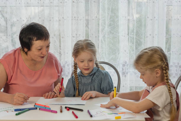 istock grandmother draws with granddaughters home 1330053426