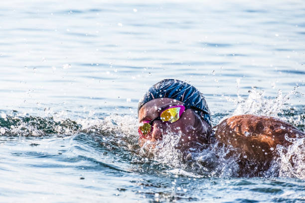 istock Professional swimmer exercising swim styles in blue sea 1330055149