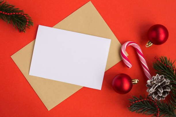 istock Blank white paper for text, envelope and Christmas composition on the red background. Top view. 1330057247
