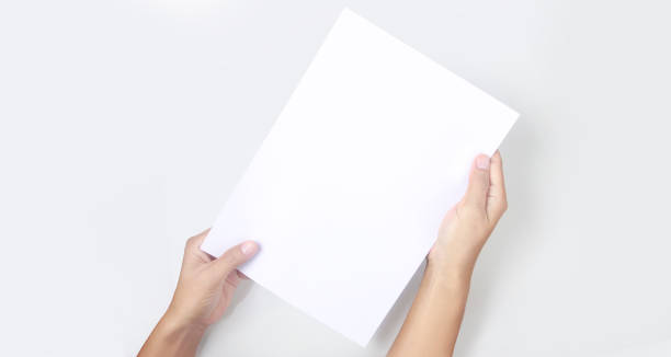 istock Hands holding paper blank for letter paper 1330059181