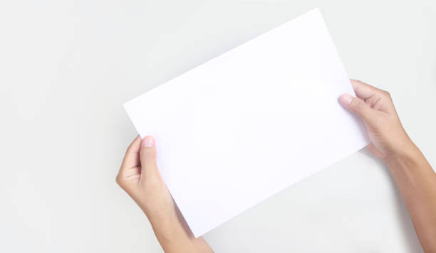 istock Hands holding paper blank for letter paper 1330059690