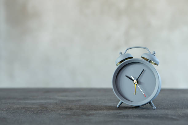 istock Vintage alarm clock on wooden table on grey background, copy space for text 1330060014