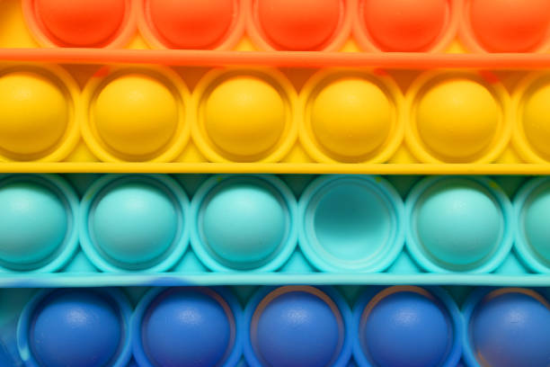 istock Trendy rainbow Pop it antistress toy. Top view, flat lay. 1330061645