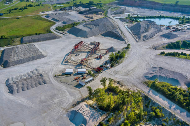 istock Panorama aerial view open pit mine mining, dumpers, quarrying extractive industry stripping work big mining trucks of machinery trucks. 1330065496