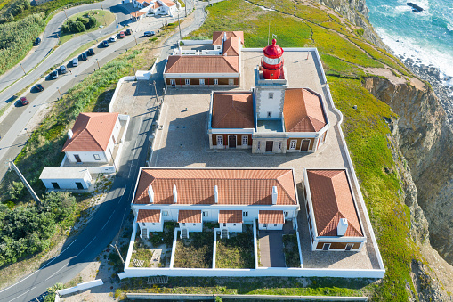 Portugal. Cabo da Roca and the lighthouse over Atlantic Ocean, the most westerly point of the European mainland. Aerial view. Concept for travel in Portugal and most beautiful places in Portugal.