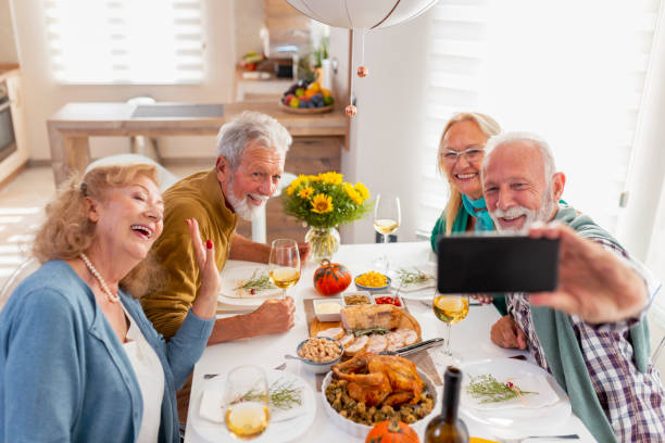 istock Senior friends taking a selfie over Thanksgiving dinner 1330066812