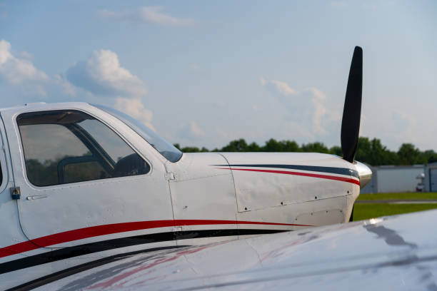 Wing, fuselage, and cockpit of a yellow and blue crop duster airplane.Aluminum siding and rivets on old military airplane. See also: