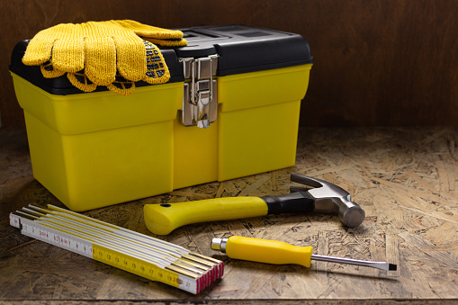 Construction tools and toolbox on wooden tablel background texture. Tools kit and tool box