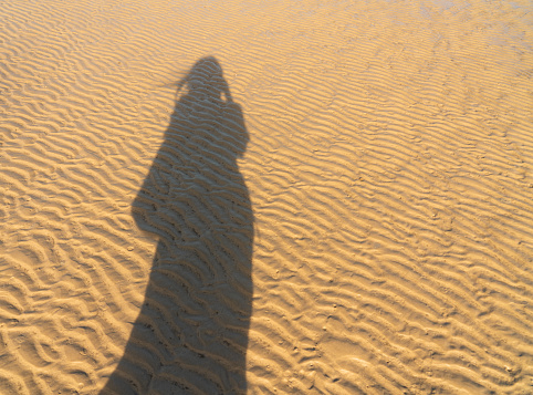 Shadow of awoman on the sand