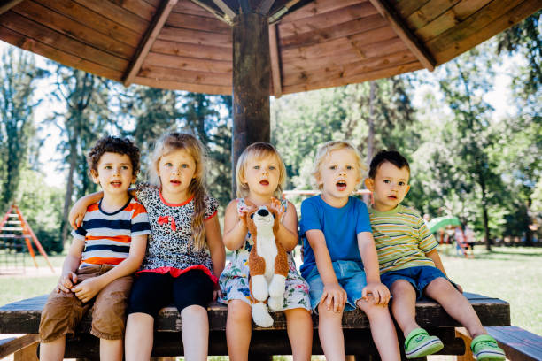 istock Kids Sits On A Park Bench 1330071770