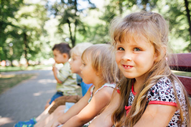 istock Kids Sits On A Park Bench 1330072287