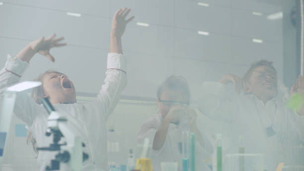 istock Curious kids conducting science experiment. Getting dirty after explosion, laughing 1330072313