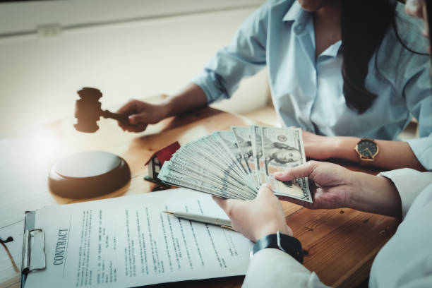 How much does a divorce cost, Legal concepts and contracts It focuses on spousal support women divorce lawyer cost holding dollars with contract documents and home purchase payments. Legal concepts and contracts It focuses on women holding dollars with contract documents and home purchase payments lawyer receiving Fees stock pictures, royalty-free photos & images