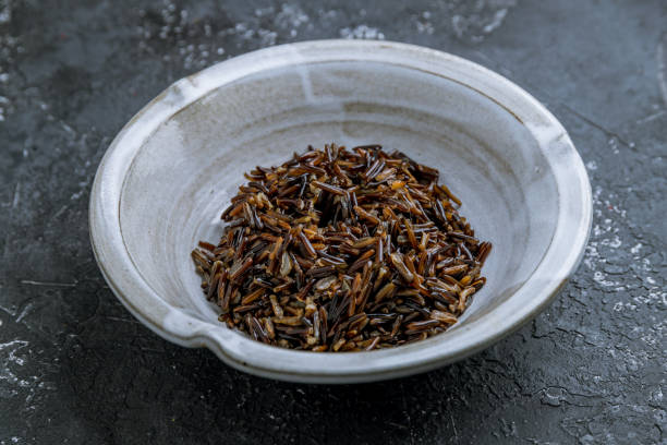 istock wild black rice boiled on grey plate on dark stone table 1330074173