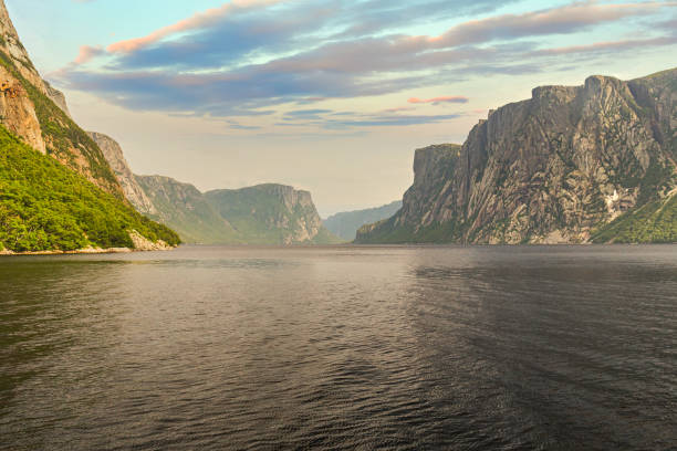 Admiring the beautiful view from the tour boat at the fjords of the Western brook pond in Gros Morne National Park, Newfoundland and Labrador, Canada stock photo