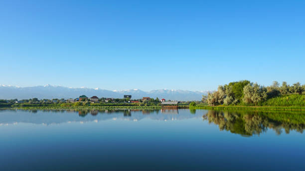 istock The mirror surface of the water reflects mountains 1330076438