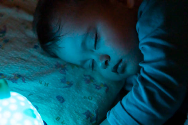 Cute baby sleeping with his favourite toy teddy bear