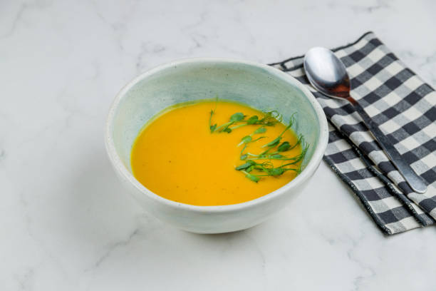 istock Soup cream of pumpkin on white marble table 1330077976