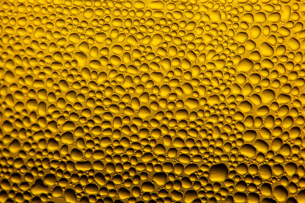 istock yellow macro water drop surface,Water Drops On Orange Background Texture colorful waterdrop 1330079119