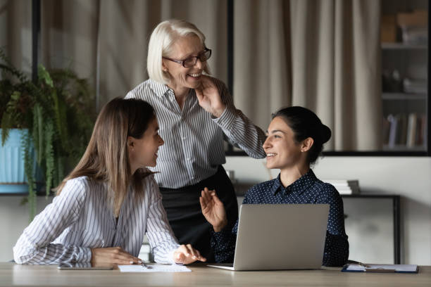 istock Diverse female office team discussing project and laughing 1330082252