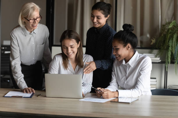 istock Happy diverse female business group working on project together 1330082260