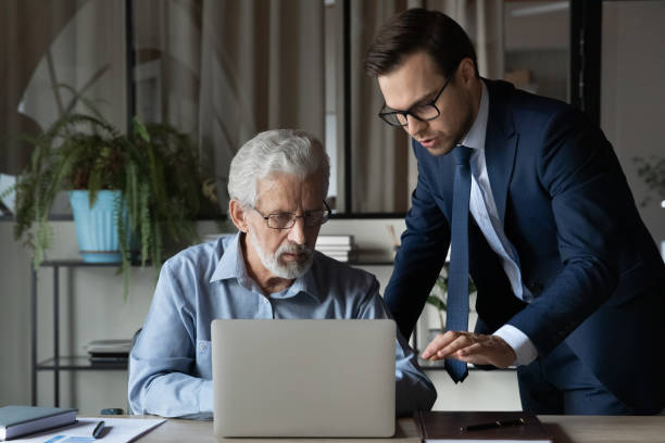 istock Senior boss consulting young expert about computer troubles 1330082314