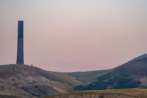 Anaconda Smelter Stack in Montana is the tallest survivng masonry building in the world, taken on a hazy night at sunset