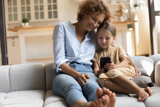 istock Happy relaxed two generations family using smartphone at home. 1330084374