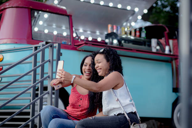 istock sisters taking a selfie with their smartphone 1330092035