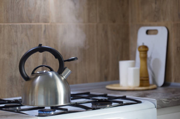 istock metal silver modern kettle on   gas stove  and utensils in kitchen 1330092148