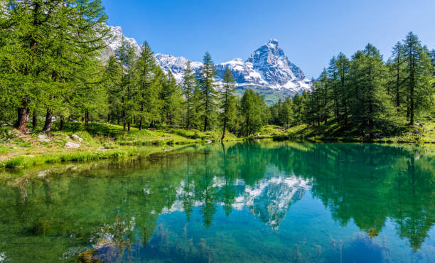 Idyllic morning view at the Blue Lake with the Matterhorn reflecting on the water, Valtournenche, Aosta Valley, Italy. stock photo