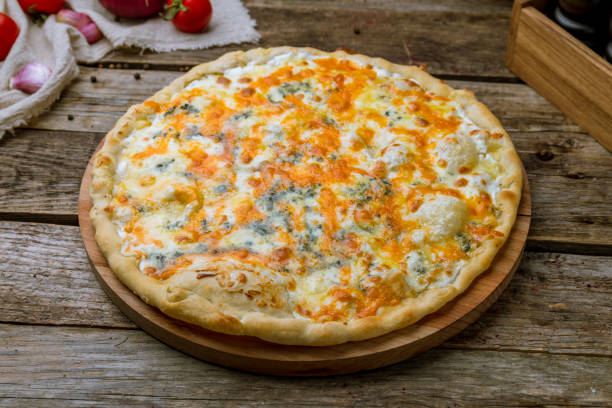 istock Pizza Quattro formaggi on wooden table 1330094199