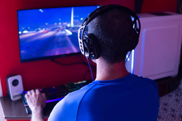 istock Young man with headphones playing videogames on a gamer desktop computer 1330094551