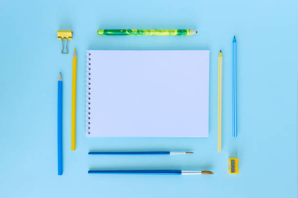 istock School supplies. Education concept. Everything for school and office. Pens, pencils and notebook on a blue background. There is a place for your text. Flatly. Mock up. From above. 1330096071