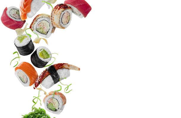 istock Assorted sushi with pickled ginger and wakame hovering on white background 1330098171