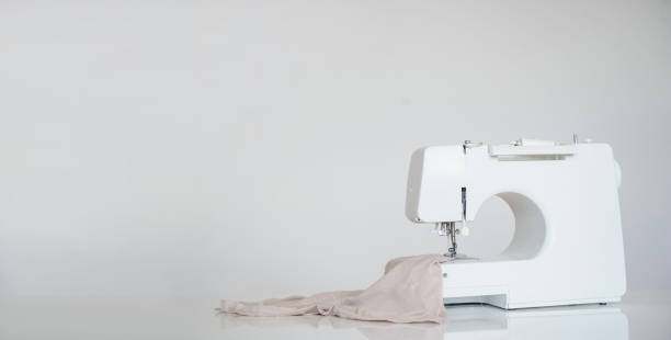 New sewing machine on grey background. New sewing machine on grey background. Copy space for your text. Sewing industry concept sewing machine stock pictures, royalty-free photos & images