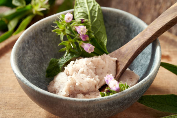 istock A bowl of homemade comfrey root ointment with fresh blooming Symphytum 1330100552