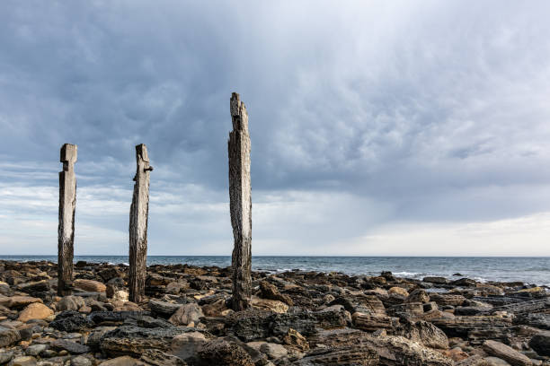 Storm brewing over Myponga Beach South Australia, seascape with remnants of old jetty. Disturbed cloudy sky landscape.